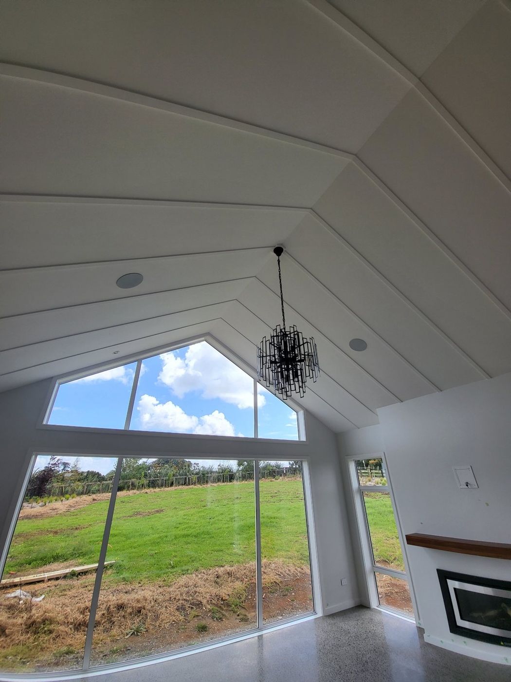 In-ceiling speakers in a raked living room ceiling
