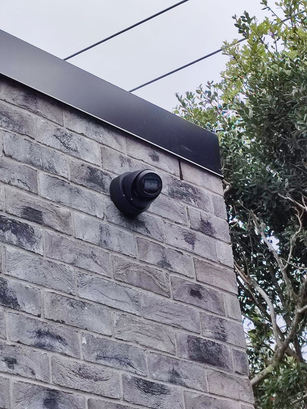 Turret camera on a brick corner