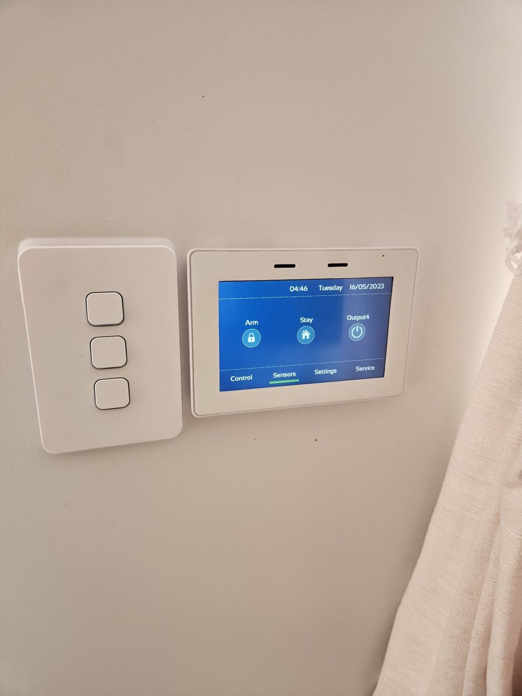 Alarm touch keypad beside the light switches