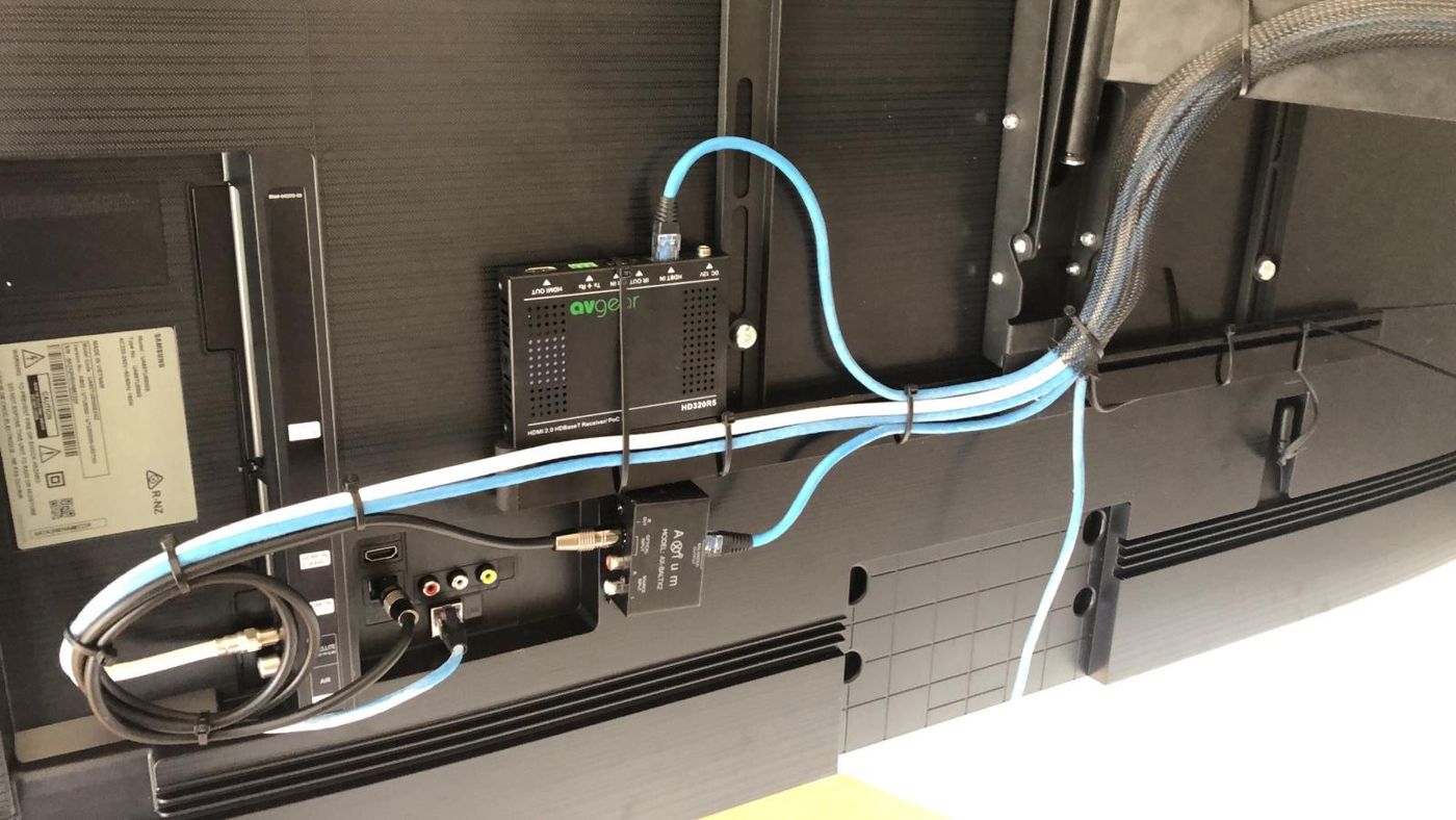 Behind the TV: HDBaseT receiver and audio, neatly cabled and tied off