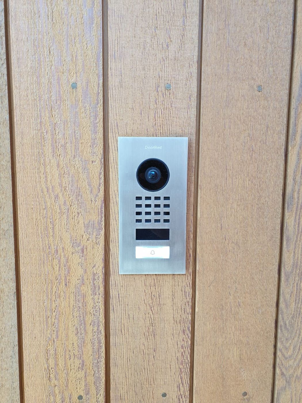 DoorBird intercom flush-mounted into cedar cladding